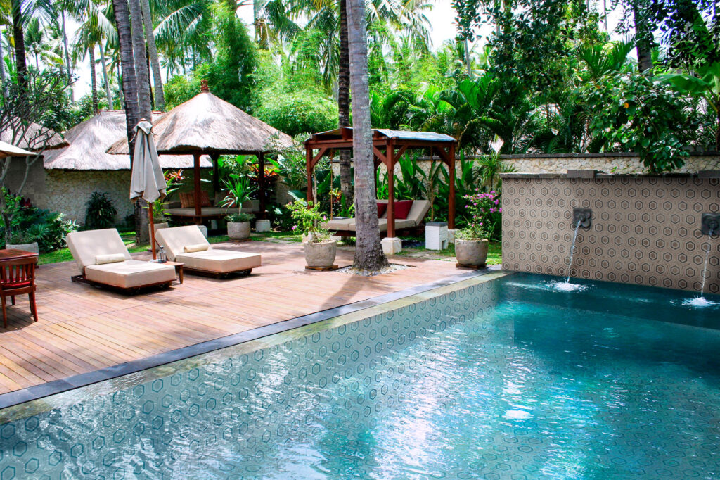 2009.10.11,,Ubud,,Bali.,Sunbeds,And,Umbrellas,Near,The,Swimming,Pool